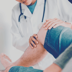 stock image showing DPT caring for patient's knee in a neutral setting